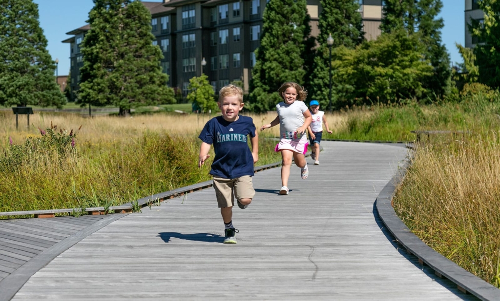 kids running on columbia tech center boardwalk